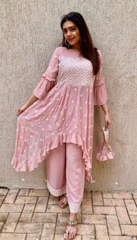 Pink chikankari long top with a high low hem with pants and matching Potli