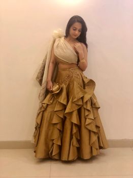 Gold ruffled skirt with a tube top and veil
