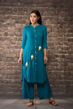 Teel blue linen silk kurta paired with matching pants.