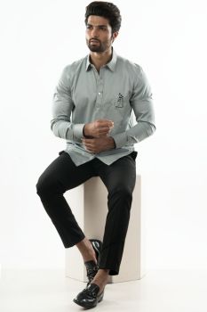 An Ice Blue Shirt With Patch Pocket Detailing And a Geometric Floral Motif.