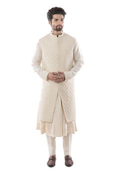 An Anarkali kurta in Silk and Cream Churidar.