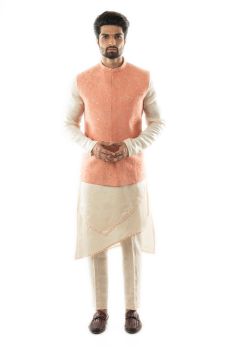 A Peach Nehru Paired with a Double Panel Kurta, Comes With Narrow Fitted Pant Pajama.