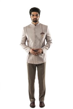 A Lavender Bandhgala in Textured Fabric With Asymmetrical Cord Piping Detail. Comes with Narrow Fitted Beige Trousers.