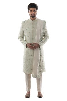 Mint Green Sherwani with Self Threadwork in Shades of Green, Using Challa and Aari Technique. Paired with Cream Silk Dupatta with Complimenting Embroidery and Cream Pant Payjama.